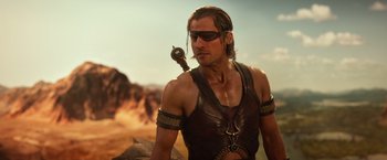 Movie still from “Gods of Egypt” (2016), directed by Alex Proyas – A person wearing a leather outfit; Medium shot, Over the shoulder angle