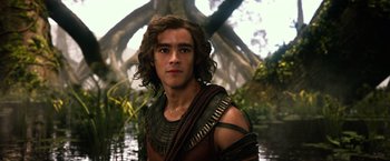 Movie still from “Gods of Egypt” (2016), directed by Alex Proyas – A young man with long brown hair wearing a brown and black outfit; Medium shot, Low angle