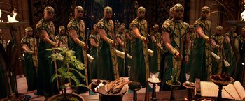 Movie still from “Gods of Egypt” (2016), directed by Alex Proyas – A group of men standing next to each other on top of a stage; Wide shot, High angle