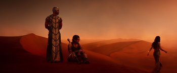 Movie still from “Gods of Egypt” (2016), directed by Alex Proyas – A woman sitting on the ground next to a man; Wide shot, Over the shoulder angle