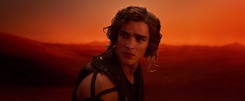 Movie still from “Gods of Egypt” (2016), directed by Alex Proyas – A man with long brown hair wearing a black shirt; Close Up shot, Over the shoulder angle