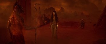 Movie still from “Gods of Egypt” (2016), directed by Alex Proyas – An image of a woman standing in the middle of the desert; Wide shot, High angle