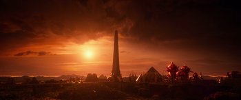 Movie still from “Gods of Egypt” (2016), directed by Alex Proyas – The sun is setting over a large monument; Extreme Wide shot, Low angle