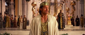 Movie still from “Gods of Egypt” (2016), directed by Alex Proyas – A man wearing a gold crown and a gold robe; Medium shot, Over the shoulder angle