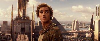 Movie still from “Gods of Egypt” (2016), directed by Alex Proyas – A young man standing on top of a building in front of pyramids; Close Up shot, Over the shoulder angle