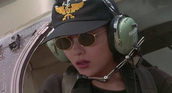 Movie still from “Godzilla vs. Destoroyah” (1995), directed by Ishirô Honda – A person wearing a hat and sunglasses with a helmet on; Close Up shot, Low angle