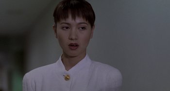 Movie still from “Godzilla vs. Destoroyah” (1995), directed by Ishirô Honda – A woman with short brown hair wearing a white shirt; Close Up shot, Over the shoulder angle
