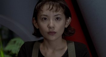 Movie still from “Godzilla vs. Destoroyah” (1995), directed by Ishirô Honda – A woman with short black hair wearing a black shirt; Close Up shot, Low angle