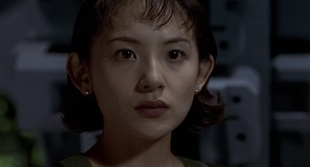 Movie still from “Godzilla vs. Destoroyah” (1995), directed by Ishirô Honda – A person with short brown hair; Close Up shot, Over the shoulder angle
