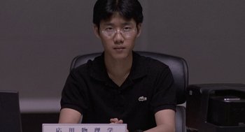 Movie still from “Godzilla vs. Destoroyah” (1995), directed by Ishirô Honda – A man sitting at a desk in front of a computer monitor; Close Up shot, Low angle