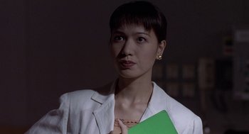 Movie still from “Godzilla vs. Destoroyah” (1995), directed by Ishirô Honda – A woman in a white jacket holding a green piece of paper; Close Up shot, Low angle