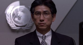 Movie still from “Godzilla vs. Destoroyah” (1995), directed by Ishirô Honda – A person wearing a suit and tie; Close Up shot, Low angle