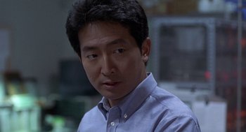 Movie still from “Godzilla vs. Destoroyah” (1995), directed by Ishirô Honda – A person wearing a blue shirt; Close Up shot, Over the shoulder angle
