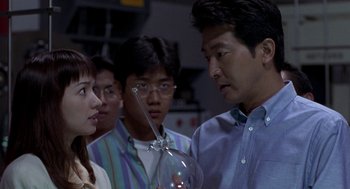 Movie still from “Godzilla vs. Destoroyah” (1995), directed by Ishirô Honda – A group of people standing next to each other in a room; Close Up shot, Over the shoulder angle