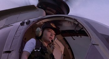 Movie still from “Godzilla vs. Destoroyah” (1995), directed by Ishirô Honda – A woman wearing a helmet and ear muffs in an aircraft; Medium shot, Low angle