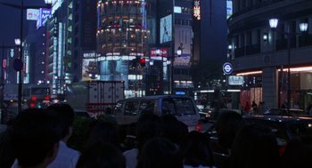 Movie still from “Godzilla vs. Destoroyah” (1995), directed by Ishirô Honda – A group of people standing in front of a building at night; Extreme Wide shot, High angle