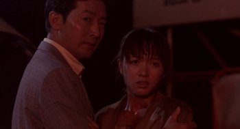 Movie still from “Godzilla vs. Destoroyah” (1995), directed by Ishirô Honda – A man and a woman standing next to each other; Close Up shot, Low angle