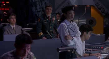 Movie still from “Godzilla vs. Destoroyah” (1995), directed by Ishirô Honda – A man and a woman in military uniforms; Medium shot, Over the shoulder angle