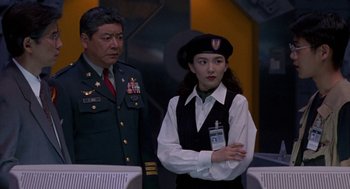 Movie still from “Godzilla vs. Destoroyah” (1995), directed by Ishirô Honda – A man and a woman standing next to each other; Medium shot, Over the shoulder angle