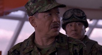 Movie still from “Godzilla vs. Destoroyah” (1995), directed by Ishirô Honda – A man in a military uniform is looking at the camera; Close Up shot, Low angle