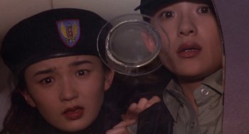 Movie still from “Godzilla vs. Destoroyah” (1995), directed by Ishirô Honda – Two young men are looking through a magnifying glass; Close Up shot, Low angle