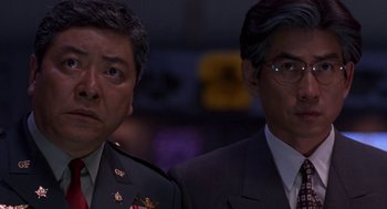 Movie still from “Godzilla vs. Destoroyah” (1995), directed by Ishirô Honda – A couple of men standing next to each other; Close Up shot, Low angle