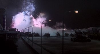 Movie still from “Godzilla vs. Destoroyah” (1995), directed by Ishirô Honda – A street light and a street light in a parking lot at night; Extreme Wide shot, Low angle