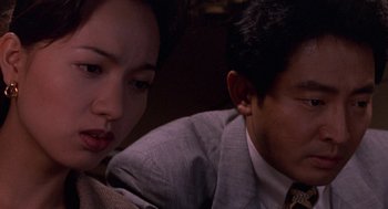 Movie still from “Godzilla vs. Destoroyah” (1995), directed by Ishirô Honda – A man and a woman sitting next to each other on a couch; Close Up shot, High angle