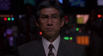Movie still from “Godzilla vs. Destoroyah” (1995), directed by Ishirô Honda – An older man wearing a suit and tie; Close Up shot, Low angle