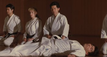 Movie still from “Godzilla vs. Mechagodzilla II” (1993), directed by Kazuki Ômori – A man and a woman in a white kimono and black belt; Medium shot, Low angle
