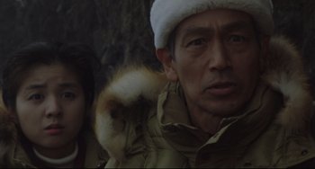 Movie still from “Godzilla vs. Mechagodzilla II” (1993), directed by Kazuki Ômori – A man and a woman wearing winter coats and hats; Close Up shot, Low angle