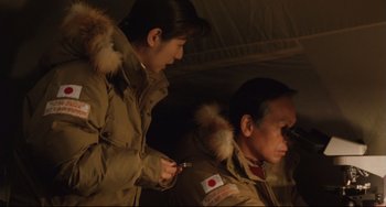 Movie still from “Godzilla vs. Mechagodzilla II” (1993), directed by Kazuki Ômori – A man and a woman in winter coats; Medium shot, High angle