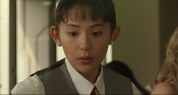 Movie still from “Godzilla vs. Mechagodzilla II” (1993), directed by Kazuki Ômori – A person wearing a tie and a vest; Close Up shot, Over the shoulder angle