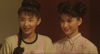 Movie still from “Godzilla vs. Mechagodzilla II” (1993), directed by Kazuki Ômori – Two young women standing next to each other in aprons; Close Up shot, Low angle