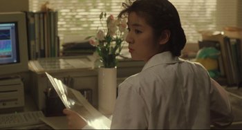 Movie still from “Godzilla vs. Mechagodzilla II” (1993), directed by Kazuki Ômori – A woman is looking at a piece of paper; Close Up shot, Over the shoulder angle