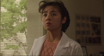 Movie still from “Godzilla vs. Mechagodzilla II” (1993), directed by Kazuki Ômori – A woman in a white lab coat looking up at the sky; Close Up shot, Low angle