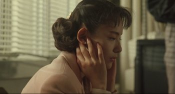 Movie still from “Godzilla vs. Mechagodzilla II” (1993), directed by Kazuki Ômori – A young woman with her hand on her ear; Close Up shot, Low angle