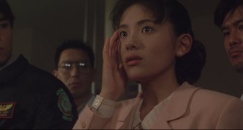 Movie still from “Godzilla vs. Mechagodzilla II” (1993), directed by Kazuki Ômori – A woman in a pink jacket and a man in a green jacket; Close Up shot, Low angle
