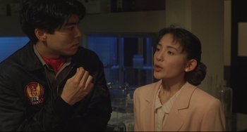 Movie still from “Godzilla vs. Mechagodzilla II” (1993), directed by Kazuki Ômori – A man and a woman talking to each other; Medium shot, Over the shoulder angle