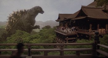 Movie still from “Godzilla vs. Mechagodzilla II” (1993), directed by Kazuki Ômori – A giant godzilla that is in the middle of a forest; Extreme Wide shot, Low angle