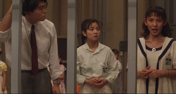 Movie still from “Godzilla vs. Mechagodzilla II” (1993), directed by Kazuki Ômori – A man and a woman standing next to each other in a room; Medium shot, Low angle