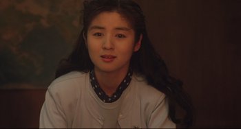 Movie still from “Godzilla vs. Mechagodzilla II” (1993), directed by Kazuki Ômori – A woman with long black hair wearing a white shirt; Close Up shot, Over the shoulder angle