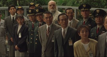 Movie still from “Godzilla vs. Mechagodzilla II” (1993), directed by Kazuki Ômori – A group of men in suits and ties standing next to each other; Wide shot, High angle