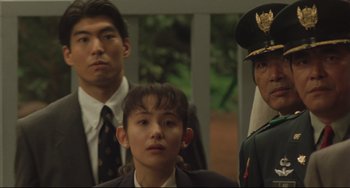 Movie still from “Godzilla vs. Mechagodzilla II” (1993), directed by Kazuki Ômori – A group of men standing next to each other; Close Up shot, Low angle