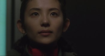 Movie still from “Godzilla vs. Mechagodzilla II” (1993), directed by Kazuki Ômori – A person's face in the dark; Close Up shot, Low angle