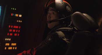 Movie still from “Godzilla vs. Mechagodzilla II” (1993), directed by Kazuki Ômori – A man wearing a helmet sitting in an airplane; Close Up shot, Over the shoulder angle