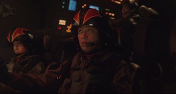 Movie still from “Godzilla vs. Mechagodzilla II” (1993), directed by Kazuki Ômori – A man wearing a helmet in a dark room; Close Up shot, Over the shoulder angle