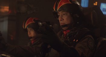 Movie still from “Godzilla vs. Mechagodzilla II” (1993), directed by Kazuki Ômori – Two men in helmets are holding guns in a dark room; Close Up shot, Low angle