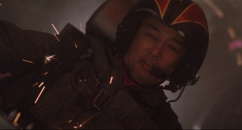 Movie still from “Godzilla vs. Mechagodzilla II” (1993), directed by Kazuki Ômori – A man wearing a helmet is flying a plane; Close Up shot, Low angle