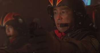 Movie still from “Godzilla vs. Mechagodzilla II” (1993), directed by Kazuki Ômori – A man wearing a helmet is looking into the distance; Close Up shot, Low angle